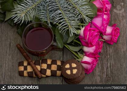 fir-tree branch, tea, roses and linking of cookies, subject holidays, food and drinks