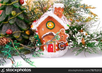 Fir tree candle and toy house on white background.