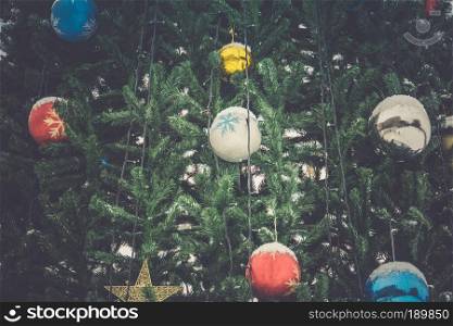 Fir tree decorated with colorful balls for Christmas time, filtered.