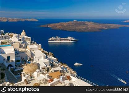 Fira, modern capital of the Greek Aegean island, Santorini, with orthodox church, cruise ships, caldera and volcano, Greece. Fira, main town of Santorini, Greece