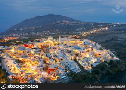 Fira, modern capital of the Greek Aegean island, Santorini, with Profitis Ilias Mountain and Orthodox Metropolitan Cathedral at night, Greece