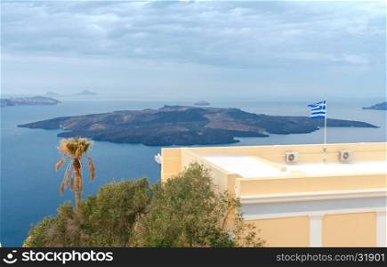 Fira. The capital of Santorini island in the Mediterranean Sea.. View of the island of Nea Kameni from Fira.