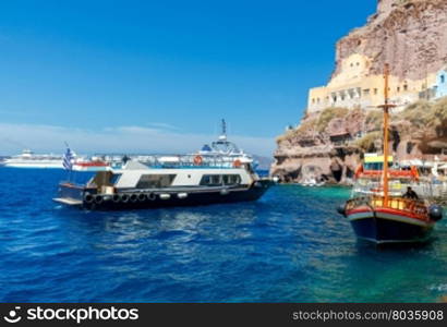 Fira. View of the old harbor.. Passenger ship in the old port of Fira early sunny morning. Santorini. Greece.