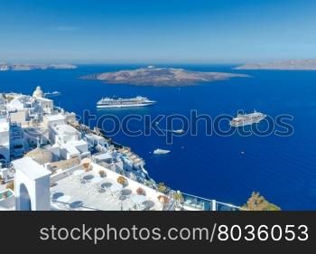 Fira. View of the old harbor.. Passenger ships in the old port of Fira early sunny morning. Santorini. Greece.