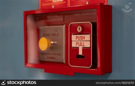Fire alarm switch on wall. Emergency alarm button installed in a building.