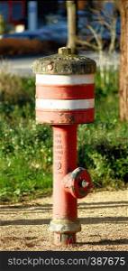 Fire-brigade hydrant with red and white stripes in Germany