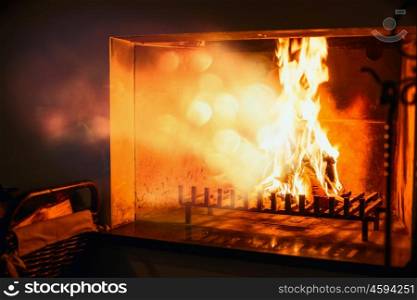 Fire burns in a fireplace , radiant heat