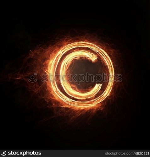 Fire copyright icon. Glowing fire copyright sign on dark background