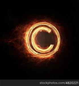 Fire copyright icon. Glowing fire copyright sign on dark background