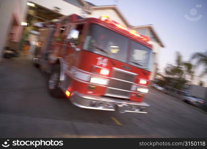 Fire engine leaving firehouse (blur)