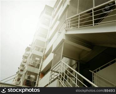 fire escape stairs with sunlight of outside buildings