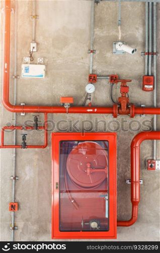 Fire extinguisher and water pump system on the wall, powerful emergency equipment for apartment and hotel