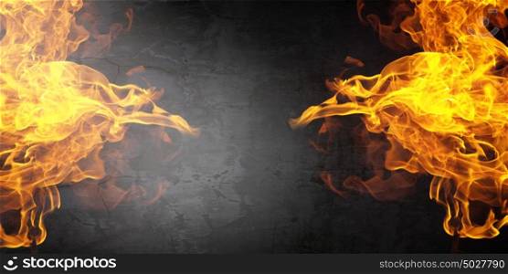 Fire flames. Background image with fire flames on cement wall