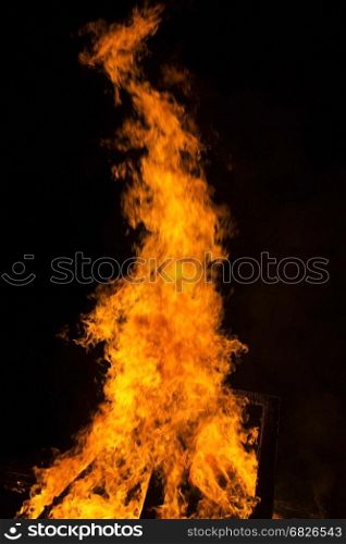 Fire flames on a black background. Blaze fire flame texture background. Close up of fire flames isolated on black background.