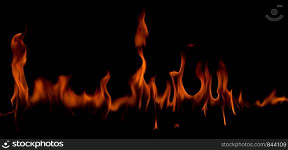 Fire flames on Abstract art black background, Burning red hot sparks rise, Fiery orange glowing flying particles