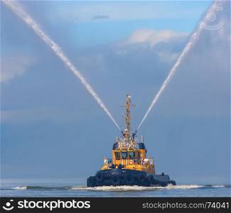 fire hose boat spraying water on Kamchatka on Paciic ocean