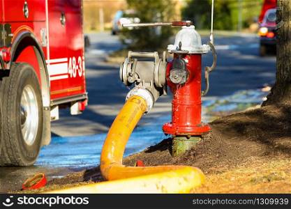 Fire hydrant water supply during emergency hooked to hose at day. Fire hydrant water supply during emergency hooked to hose