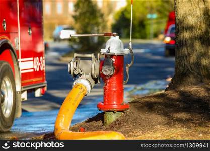 Fire hydrant water supply during emergency hooked to hose at day. Fire hydrant water supply during emergency hooked to hose