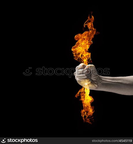 Fire in hand. Close up of human hand holding fire flame