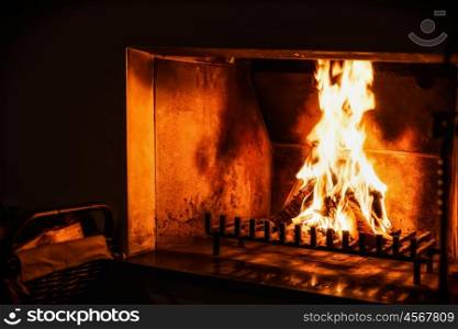 Fire in the old fireplace in dark room