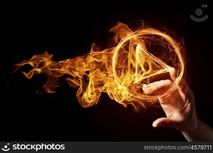 Fire play icon. Finger touch glowing fire play icon on dark background