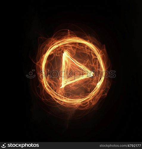 Fire play icon. Glowing fire play icon on dark background
