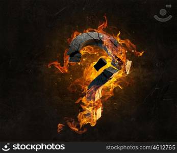 Fire question mark. Stone question mark in fire flames on dark background