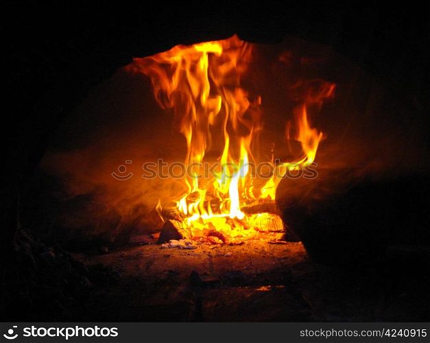 Fire wood brighly burning in the furnace