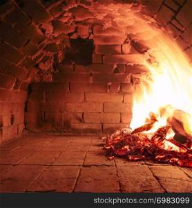Fire wood burning in an old oven ready to cook