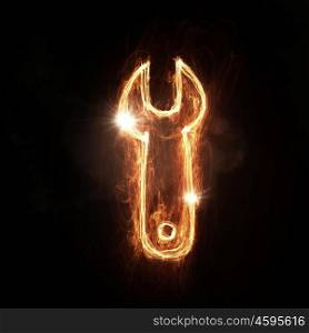 Fire wrench icon. Fire wrench glowing icon on dark background