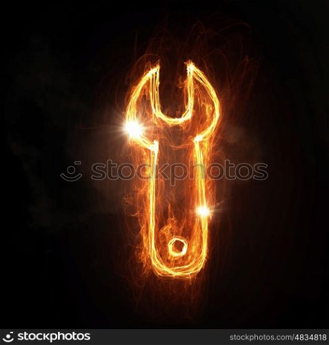 Fire wrench icon. Fire wrench glowing icon on dark background