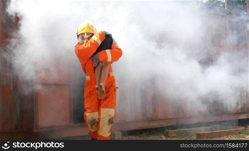 Firefighter fighting with flame using fire hose chemical water foam spray engine. Fireman wear hard hat, body safe suit uniform for protection. Rescue training in fire fighting extinguisher