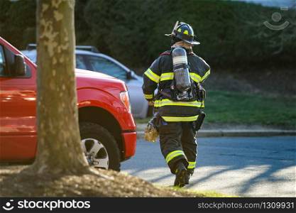 Firefighter service at work with protective gear at day. Firefighter at work with protective gear at day