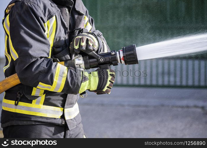 Firefighters who use fire extinguishers and hose water to fight fires