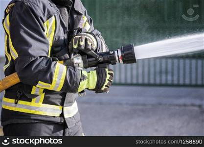 Firefighters who use fire extinguishers and hose water to fight fires