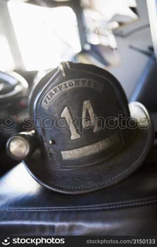 Firefighting helmet in fire engine on seat (selective focus)