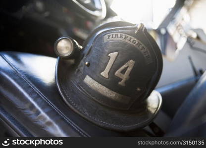 Firefighting helmet in fire engine on seat (selective focus)