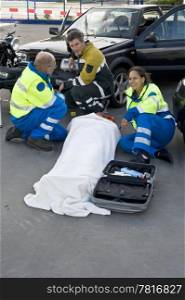 fireman and paramedics sitting begind a victim