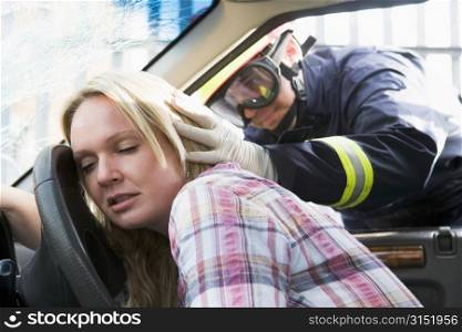 Fireman helping a woman after she got in an accident