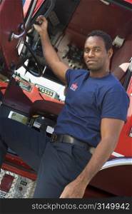 Fireman leaning in door of fire engine