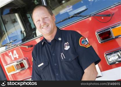 Fireman standing in front of fire engine