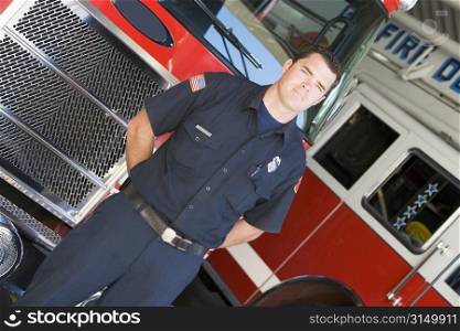 Fireman standing in front of fire engines