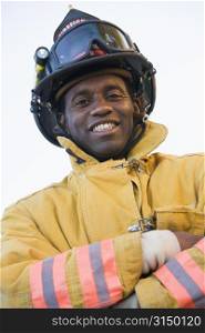 Fireman standing outdoors wearing helmet