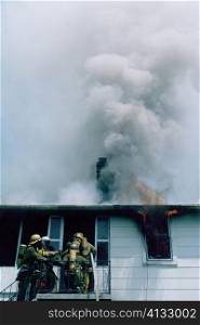 Firemen at work on a burning house in Maryland