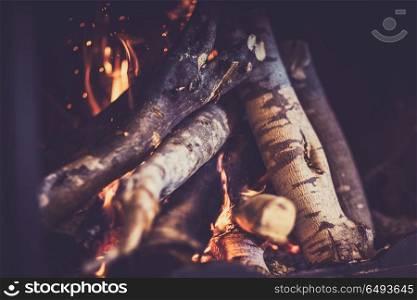 Fireplace, burning woodpile background, cozy romantic winter evening near fire place. Fireplace