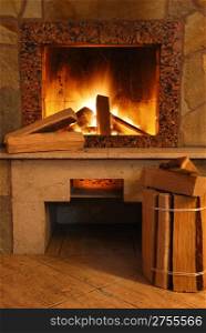 Fireplace. Flaring fire in a fireplace the reveted wild stone and a marble