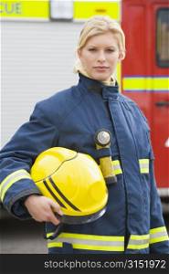 Firewoman standing by fire engine
