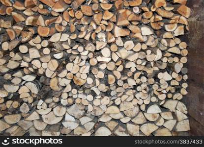 Firewood heap stored in an old woodshed.