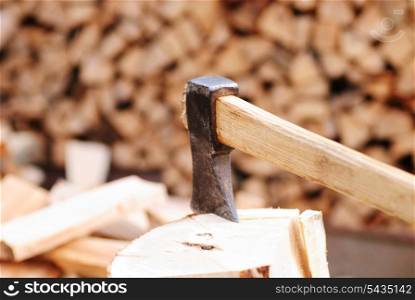Firewood with axe and male hand. close up, shallow deep of field