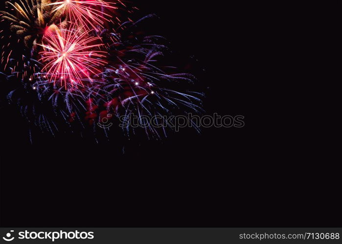 Fireworks abstract on dark background.Colorful firework on the night sky. New Year celebration fireworks. Abstract firework on black background with free space for text